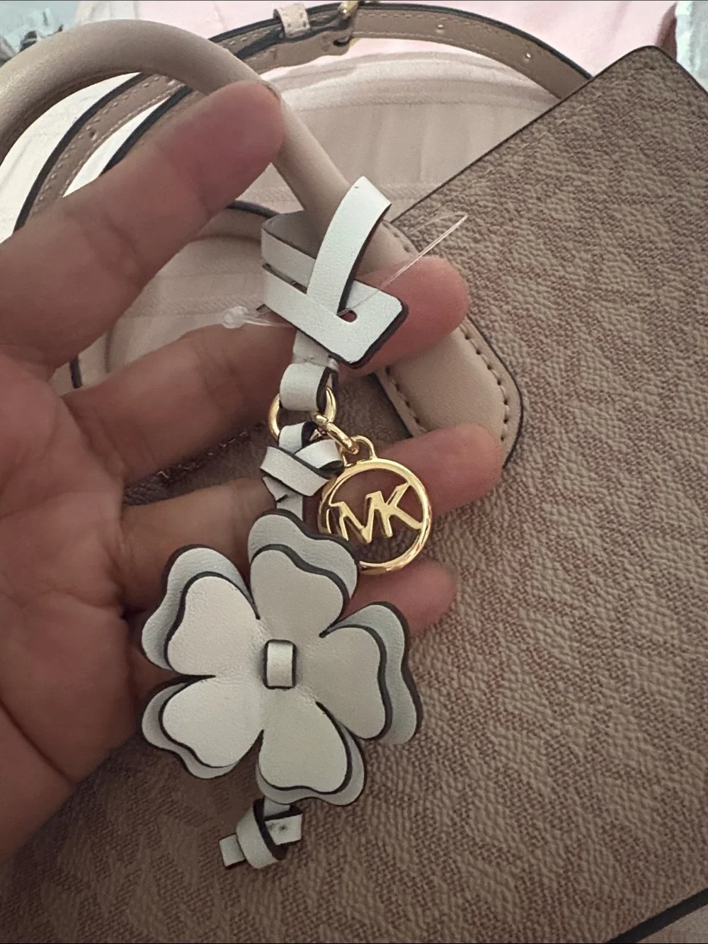 A cute MICHAEL KORS Blush Pink Logo Satchel with Floral Charm